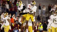 Notre Dame safeties Tae Johnson (9) and Adon Shuler (8) leap and celebrate an interception in the fourth quarter against the Boston College Eagles at Alumni Stadium.