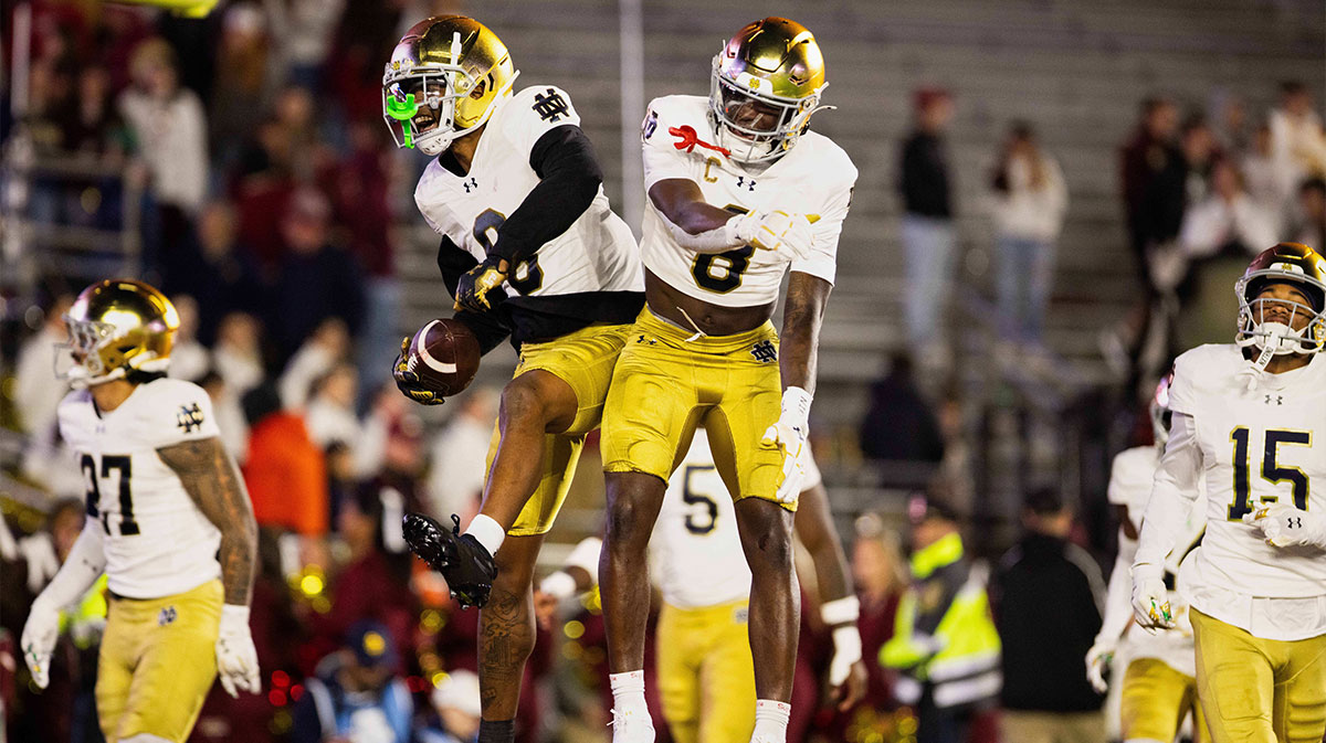 Notre Dame safeties Tae Johnson (9) and Adon Shuler (8) leap and celebrate an interception in the fourth quarter against the Boston College Eagles at Alumni Stadium.