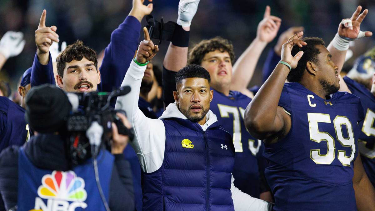 Notre Dame head coach Marcus Freeman celebrates with his players after winning a NCAA football game 70-7 against Syracuse.
