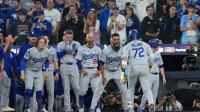 Los Angeles Dodgers second baseman Miguel Rojas (72) reacts after hitting a home run against the Toronto Blue Jays in the ninth inning for game seven of the 2025 MLB World Series at Rogers Centre. Mandatory Credit: Nick Turchiaro-Imagn Images