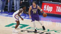 Los Angeles Lakers guard Luka Doncic (77) moves the ball as Oklahoma City Thunder guard Isaiah Joe (11) defends during the first quarter at Paycom Center. Mandatory Credit: Alonzo Adams-Imagn Images