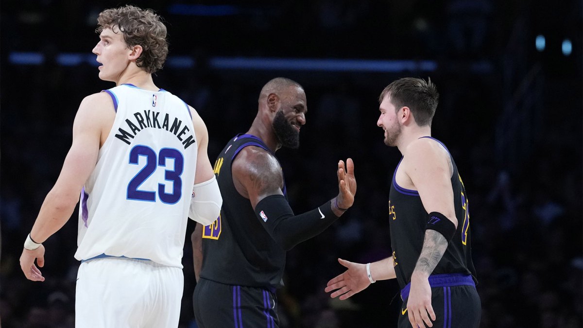 Los Angeles Lakers forward LeBron James (center) and guard Luka Doncic (77) react as Utah Jazz forward Lauri Markkanen (23) watches in the fourth quarter at Crypto.com Arena. Mandatory Credit: Kirby Lee-Imagn Images