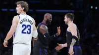 Los Angeles Lakers forward LeBron James (center) and guard Luka Doncic (77) react as Utah Jazz forward Lauri Markkanen (23) watches in the fourth quarter at Crypto.com Arena. Mandatory Credit: Kirby Lee-Imagn Images