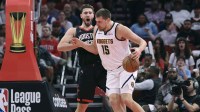Nuggets center Nikola Jokic (15) controls the ball
