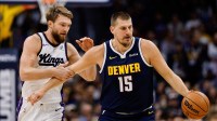 Denver Nuggets center Nikola Jokic (15) dribbles the ball up court as Sacramento Kings forward Domantas Sabonis (11) defends in the first quarter at Ball Arena.
