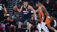 Nuggets center Nikola Jokic (15) moves the ball