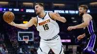 Nuggets center Nikola Jokic (15) reaches for the ball