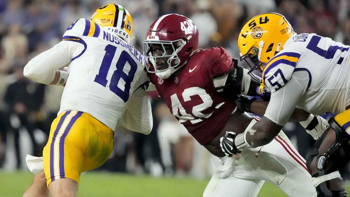 Alabama linebacker Yhonzae Pierre (42) fights off a block by LSU offensive lineman Carius Curne (57) to sack LSU quarterback Garrett Nussmeier (18) for a loss at Saban Field at Bryant-Denny Stadium. Alabama defeated LSU 20-9.