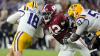 Alabama linebacker Yhonzae Pierre (42) fights off a block by LSU offensive lineman Carius Curne (57) to sack LSU quarterback Garrett Nussmeier (18) for a loss at Saban Field at Bryant-Denny Stadium. Alabama defeated LSU 20-9.