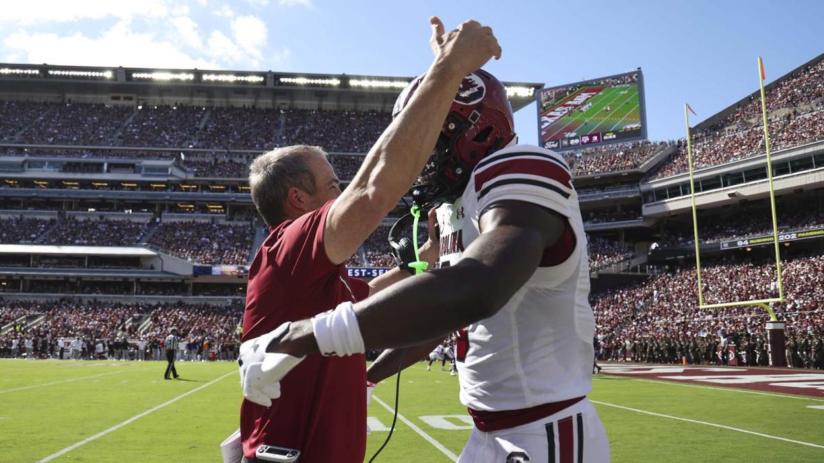 South Carolina Gamecocks wide receiver Nyck Harbor (8) is embraced by head coach Shane Beamer after scoring a touchdown during the second quarter against the Texas A&M Aggies at Kyle Field.