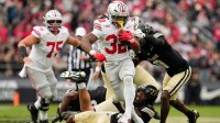 Ohio State Buckeyes running back Isaiah West (32) breaks a tackle attempt by Purdue Boilermakers defensive back Tony Grimes (0) during the NCAA football game at Ross-Ade Stadium in West Lafayette, Ind. on Nov. 8, 2025. Ohio State won 34-10.