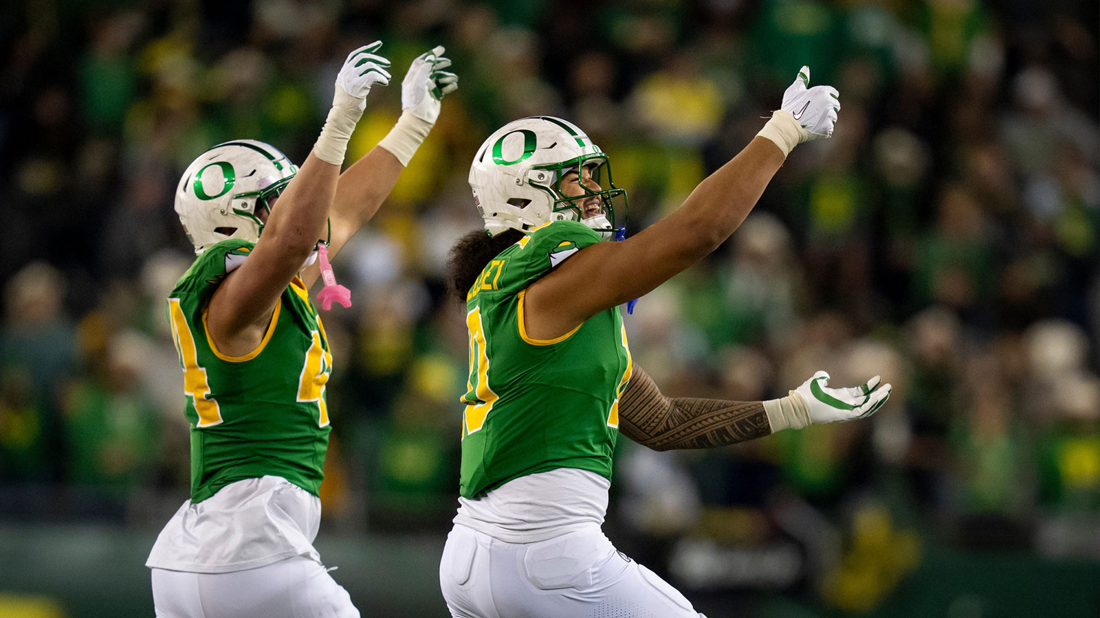 Oregon outside linebackers Matayo Uiagalelei, right, and Teitum Tuioti take the field as the Oregon Ducks host the Minnesota Golden Gophers on Nov. 14, 2025, at Autzen Stadium in Eugene, Oregon.