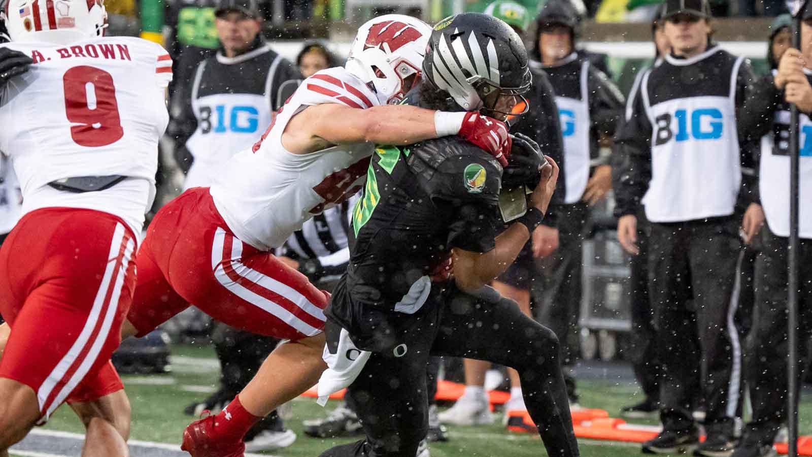 Oregon quarterback Dante Moore is brought down by Wisconsin linebacker Cooper Catalano on a run as the Oregon Ducks host the Wisconsin Badgers on Oct. 25, 2025, at Autzen Stadium in Eugene, Oregon.