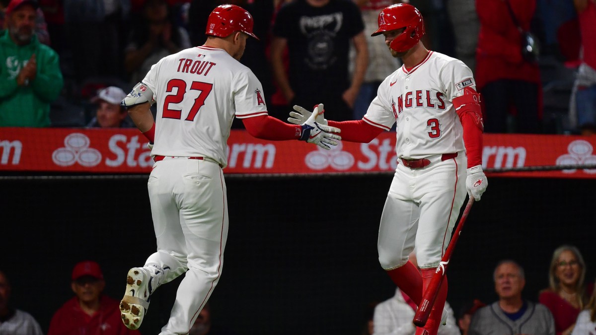 Los Angeles Angels designated hitter Mike Trout (27) is greeted by left fielder Taylor Ward (3) after hitting a solo home run against the Houston Astros during the fourth inning at Angel Stadium.