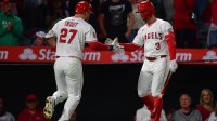 Los Angeles Angels designated hitter Mike Trout (27) is greeted by left fielder Taylor Ward (3) after hitting a solo home run against the Houston Astros during the fourth inning at Angel Stadium.