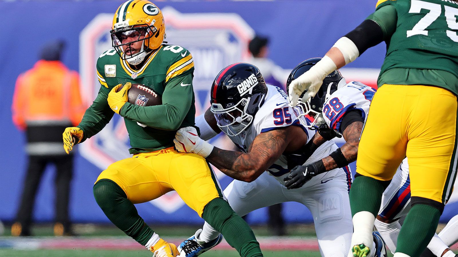 Green Bay Packers running back Josh Jacobs (8) runs the ball against New York Giants defensive tackle Roy Robertson-Harris (95) during the first quarter at MetLife Stadium.