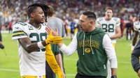 Green Bay Packers head coach Matt LaFleur celebrates with safety Xavier McKinney (29) after defeating the Arizona Cardinals at State Farm Stadium.