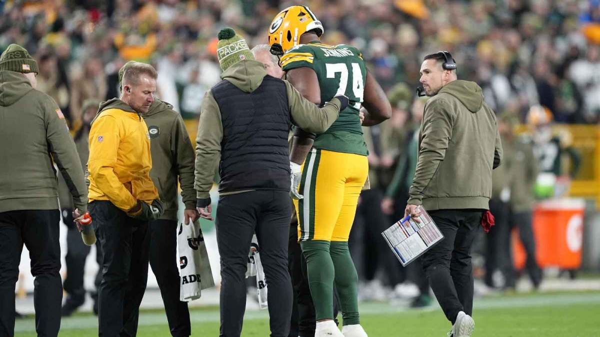 Green Bay Packers guard Elgton Jenkins (74) comes off the file with an apparent injury against the Green Bay Packers in the first half at Lambeau Field.