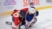 Florida Panthers left wing A.J. Greer (10) and Edmonton Oilers center Trent Frederic (10) fight during the first period at Amerant Bank Arena.