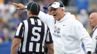 Pittsburgh Panthers head coach Pat Narduzzi (right) reacts to side judge Aaron Hochuli against the North Carolina State Wolfpack during the second quarter at Acrisure Stadium.