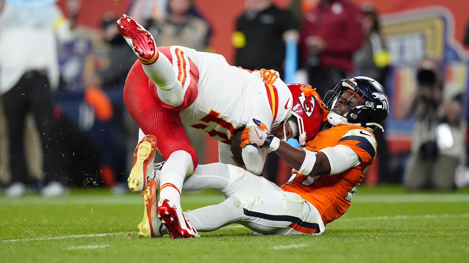 Denver Broncos cornerback Ja'Quan McMillian (29) sacks Kansas City Chiefs quarterback Patrick Mahomes (15) in the fourth quarter at Empower Field at Mile High.