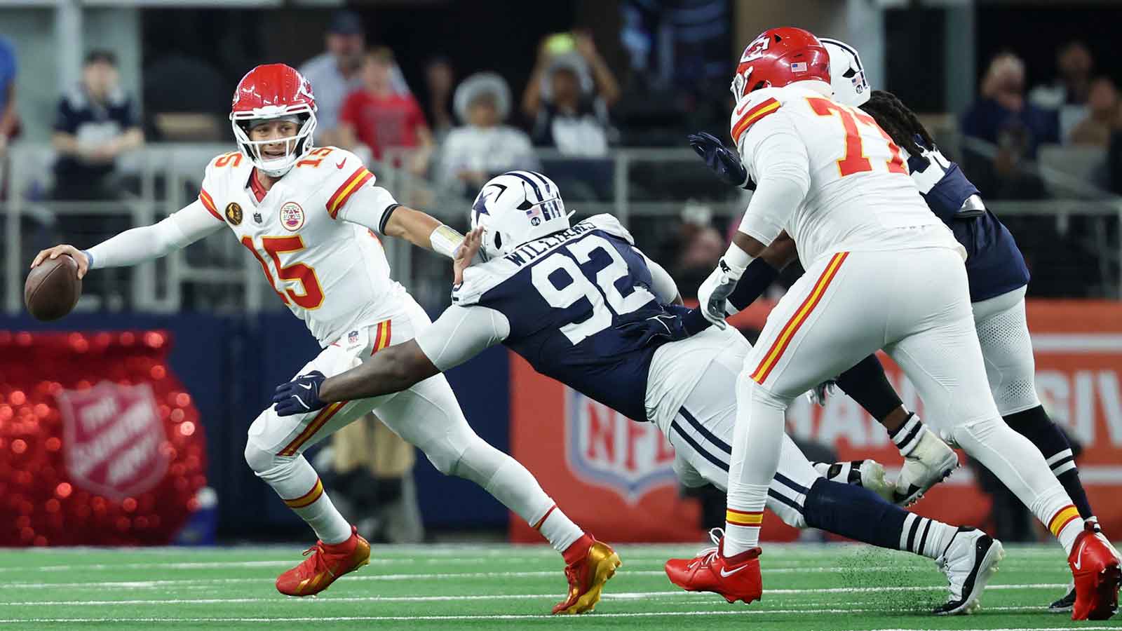 Kansas City Chiefs quarterback Patrick Mahomes (15) runs with the ball against Dallas Cowboys defensive tackle Quinnen Williams (92) during the second quarter at AT&T Stadium.