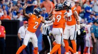 Denver Broncos linebacker Justin Strnad (40) celebrates his interception with linebacker Alex Singleton (49) and cornerback Pat Surtain II (2) in the fourth quarter against the New York Giants at Empower Field at Mile High.