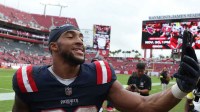 New England Patriots running back Treveyon Henderson (32) walks off field following a game against the Tampa Bay Buccaneers at Raymond James Stadium.