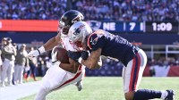 Atlanta Falcons offensive tackle Jake Matthews (70) is knocked out of bounds by New England Patriots cornerback Christian Gonzalez (0) during the first half at Gillette Stadium.