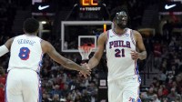 Philadelphia 76ers center Joel Embiid (21) and forward Paul George (8) high five during the second half against the Portland Trail Blazers at Moda Center.
