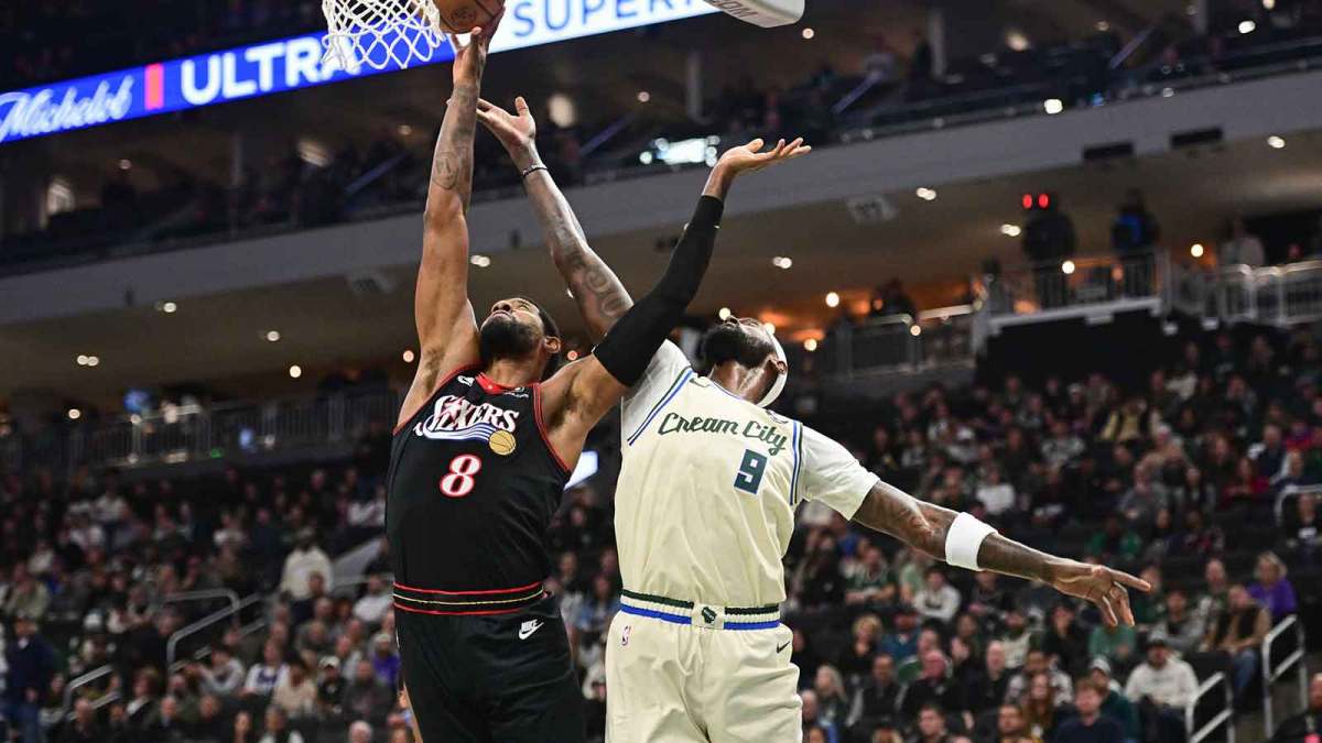 Milwaukee Bucks forward Bobby Portis (9) and Philadelphia 76ers forward Paul George (8) battle for a rebound in the first quarter at Fiserv Forum.