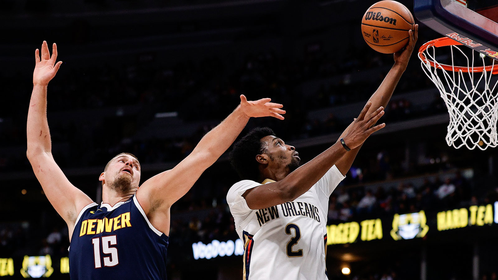 Pelicans forward Herb Jones (2) drives to the basket against Denver Nuggets center Nikola Jokic (15) in the first quarter at Ball Arena