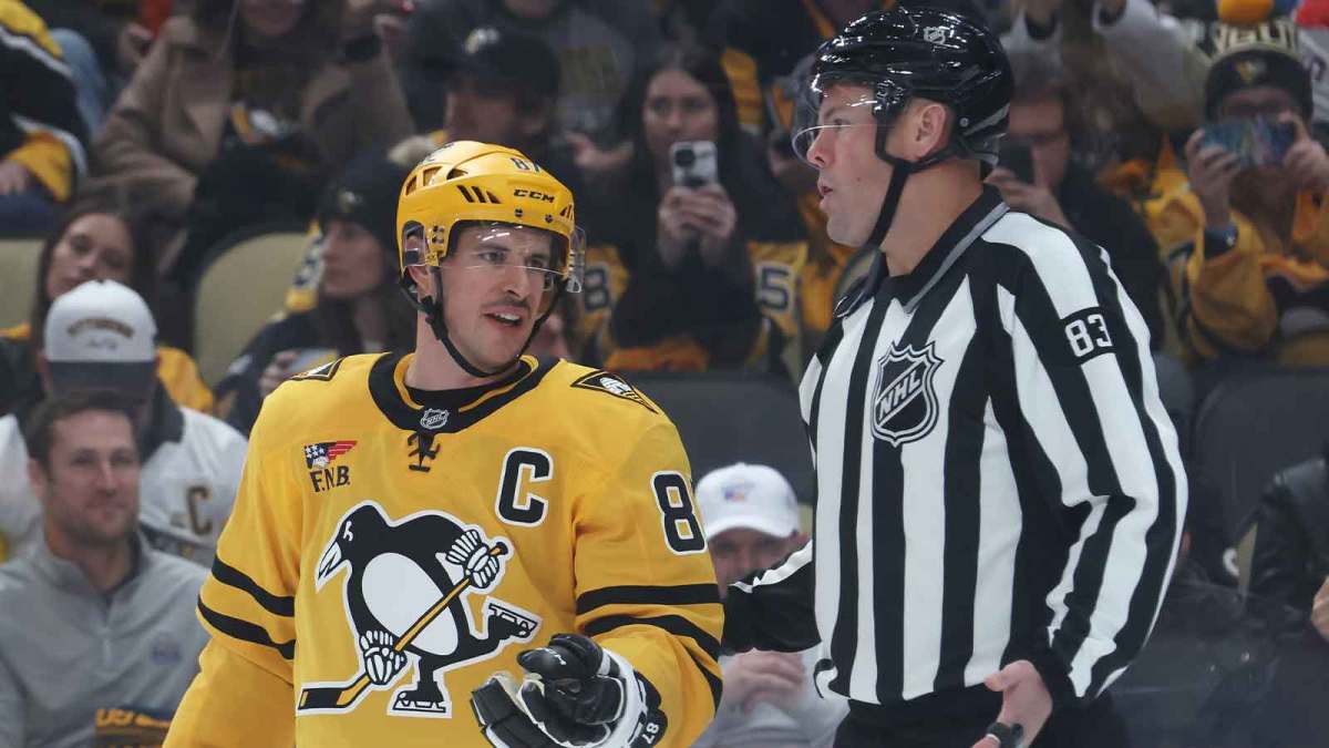 ; Pittsburgh Penguins center Sidney Crosby (87) talks with linesman Matt MacPherson (83) against the Washington Capitals during the first period at PPG Paints Arena.