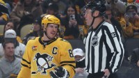 ; Pittsburgh Penguins center Sidney Crosby (87) talks with linesman Matt MacPherson (83) against the Washington Capitals during the first period at PPG Paints Arena.