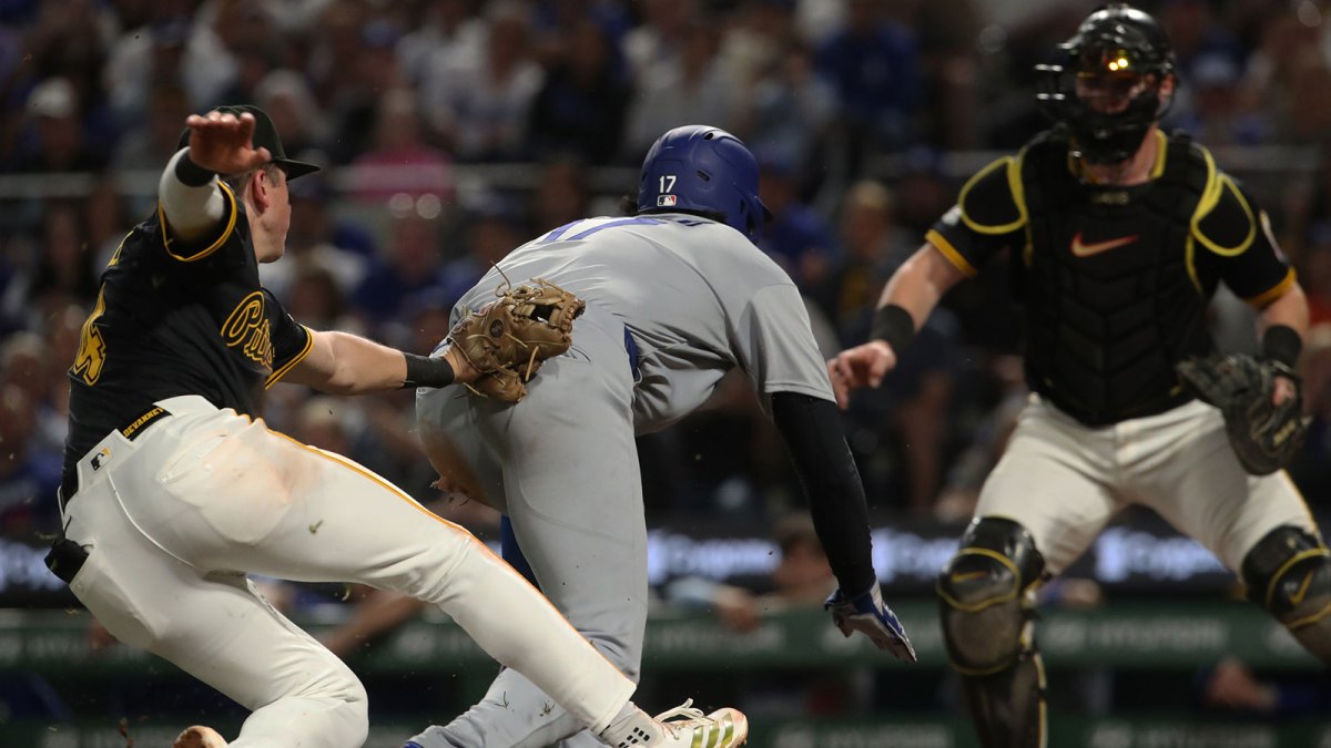 Pittsburgh Pirates third baseman Cam Devanney (left) tags Los Angeles Dodgers two-way player Shohei Ohtani (17) out in a run down during the seventh inning at PNC Park.