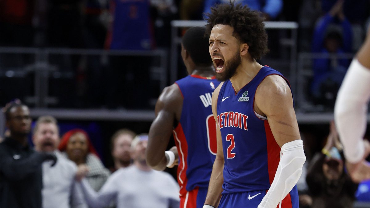 Pistons guard Cade Cunningham (2) celebrates in overtime against the Washington Wizards at Little Caesars Arena with the Cavs logo in the background