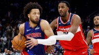 Detroit Pistons guard Cade Cunningham (2) dribbles defended by Washington Wizards center Alex Sarr (20) in overtime at Little Caesars Arena.