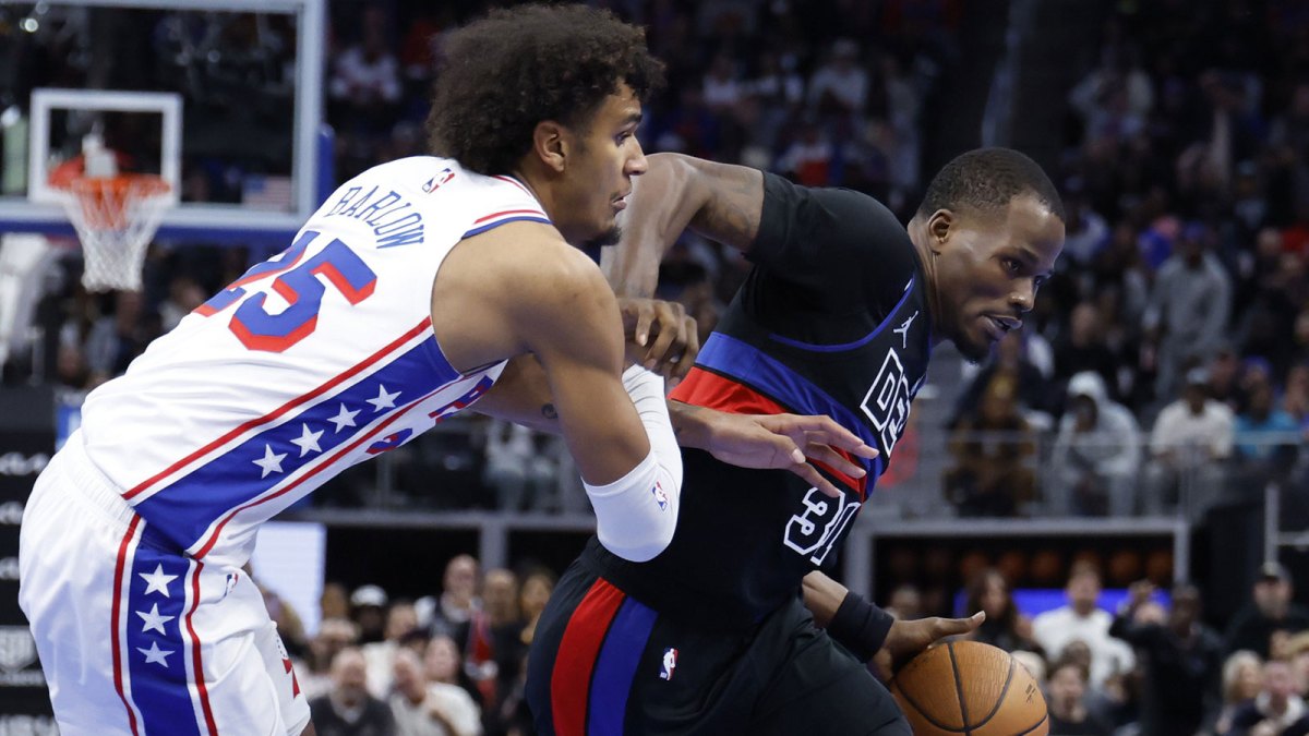 Detroit Pistons guard Javonte Green (31) dribbles defended by Philadelphia 76ers forward Dominick Barlow (25) in the second half at Little Caesars Arena.