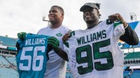 New York Jets defensive tackle Quinnen Williams (95) and Jacksonville Jaguars linebacker Quincy Williams (56) exchange jerseys after the game between the Jacksonville Jaguars and the New York Jets at TIAA Bank Field.