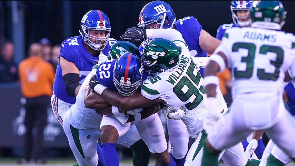 New York Jets defensive tackle Quinnen Williams (95) tackles New York Giants running back Wayne Gallman (22) during the first quarter at MetLife Stadium.