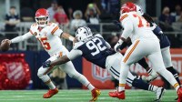 Kansas City Chiefs quarterback Patrick Mahomes (15) runs with the ball against Dallas Cowboys defensive tackle Quinnen Williams (92) during the second quarter at AT&T Stadium.