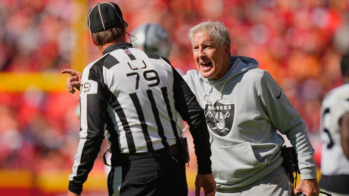Las Vegas Raiders head coach Pete Carroll speaks to line judge Kent Payne (79) after a play against the Kansas City Chiefs during the third quarter of the game at GEHA Field at Arrowhead Stadium.