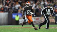 Cleveland Browns quarterback Shedeur Sanders (12) runs for a gain during the fourth quarter against the Baltimore Ravens at Huntington Bank Field.