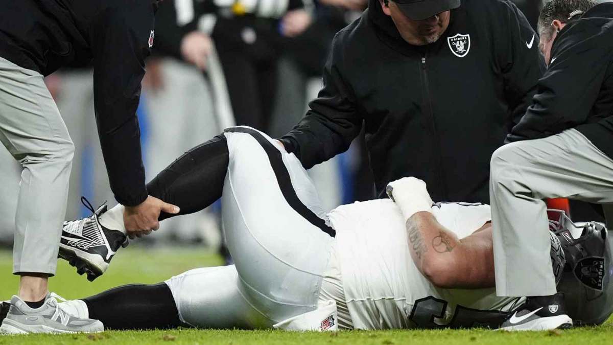 Las Vegas Raiders guard Jackson Powers-Johnson (58) is rendered aid from the training staff against the Denver Broncos during the first half at Empower Field at Mile High.