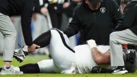 Las Vegas Raiders guard Jackson Powers-Johnson (58) is rendered aid from the training staff against the Denver Broncos during the first half at Empower Field at Mile High.