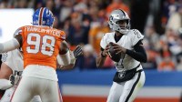 Las Vegas Raiders quarterback Geno Smith (7) drops back to pass against the Denver Broncos during the first half at Empower Field at Mile High.