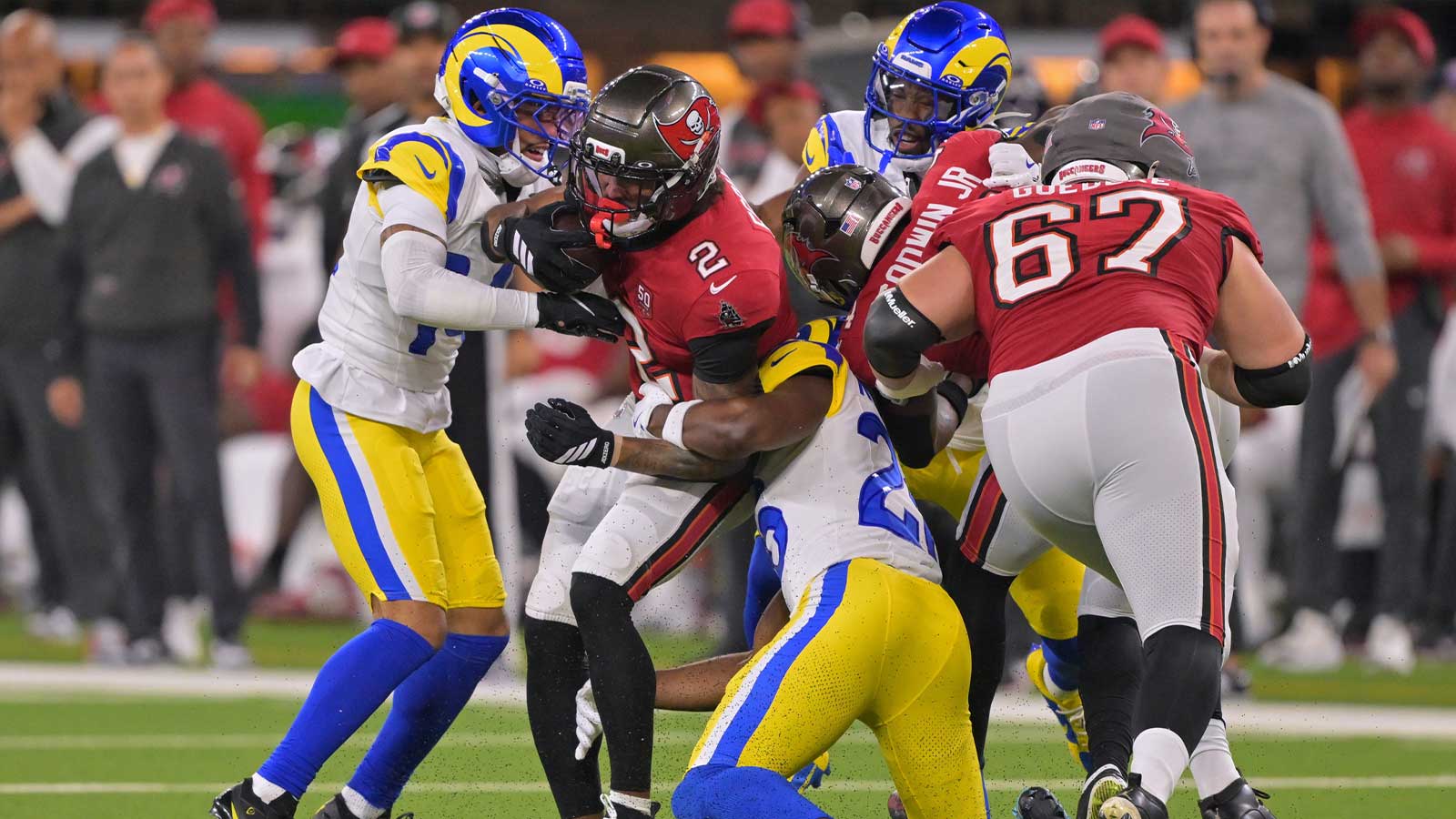 Tampa Bay Buccaneers wide receiver Emeka Egbuka (2) is tackled by Los Angeles Rams cornerback Cobie Durant (14) and safety Kamren Kinchens (26) during the first quarter at SoFi Stadium.
