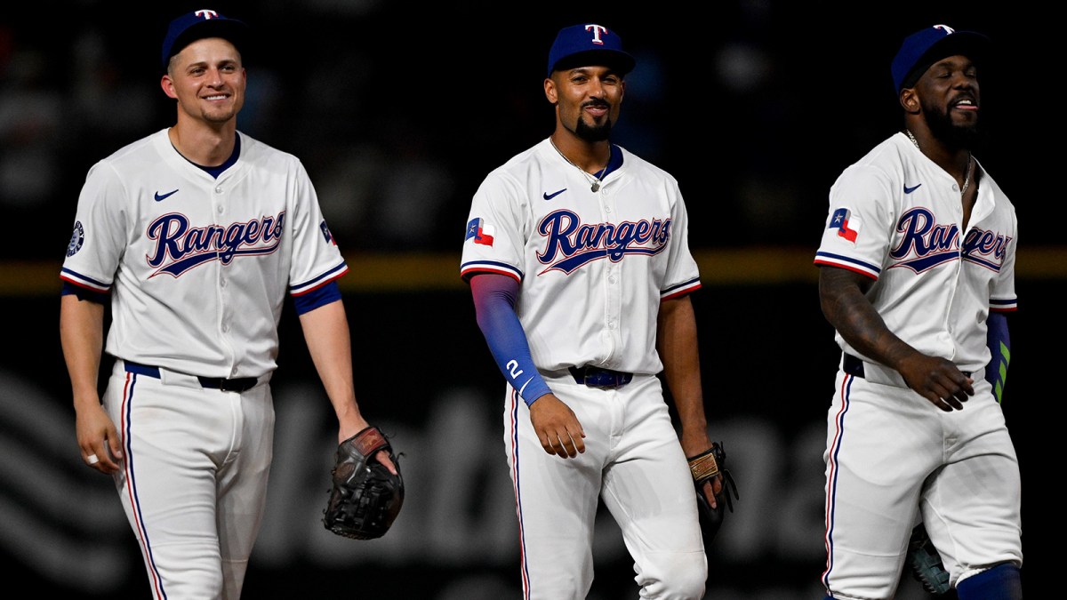 Texas Rangers shortstop Corey Seager (5) and second baseman Marcus Semien (2) and right fielder Adolis Garcia (53) come off the field after the win over the Baltimore Orioles at Globe Life Field.