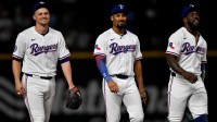 Texas Rangers shortstop Corey Seager (5) and second baseman Marcus Semien (2) and right fielder Adolis Garcia (53) come off the field after the win over the Baltimore Orioles at Globe Life Field.