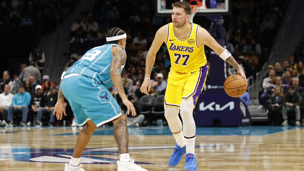 Los Angeles Lakers forward/guard Luka Doncic (77) is guarded by Charlotte Hornets guard Tre Mann (23) during the second quarter at Spectrum Center. Lakers forward/guard Luka Doncic (77) is guarded by Charlotte Hornets guard Tre Mann (23)